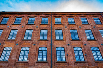 Fototapeta na wymiar Beautifully renovated facade of an old textile factory