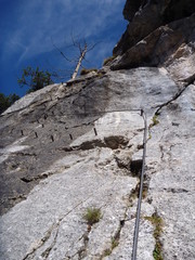 via ferrata steel rope on a rock