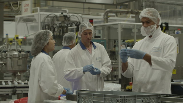  Workers in protective clothing in pharmaceutical and cosmetics factory