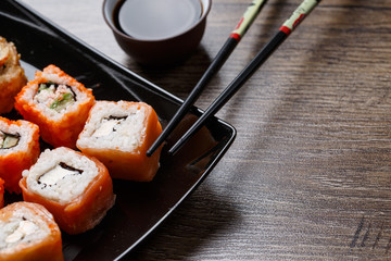 Sushi roll with chopsticks