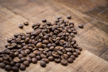 Fototapeta na wymiar High quality coffee beans on dark wooden background.