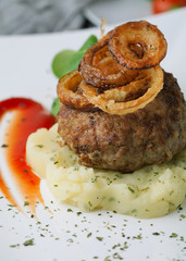 Mashed potatoes and meat cutlet on a plate