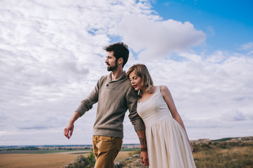 couple in the field near the mountains