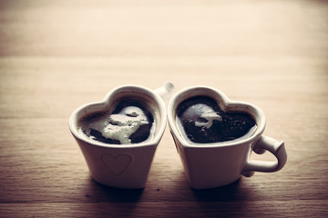 Black coffee, espresso in two heart shaped cups.. Love, Valentine's Day, vintage