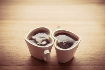 Black coffee, espresso in two heart shaped cups.. Love, Valentine's Day, vintage