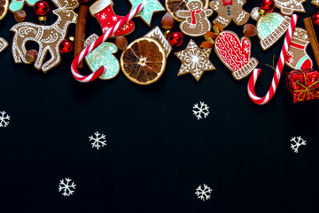 Christmas background with gingerbread, cinnamon, orange, candy a