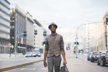 Knee figure of young handsome afro black man walking in the stre
