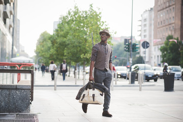 Young handsome afro black man walking in the street of the city, - obrazy, fototapety, plakaty