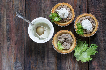 Preparation tartlets with liver paste, ricotta and lettuce