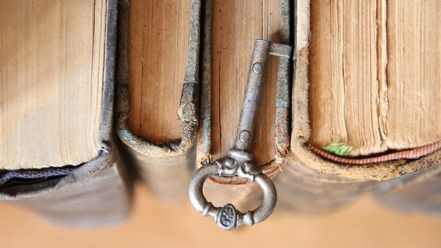 Old vintage key and old books, education is the key idea.
