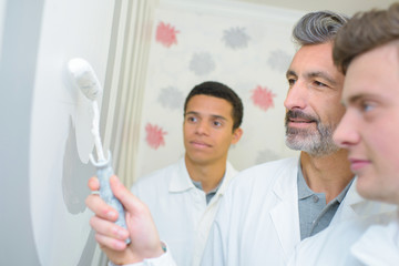 men with roller brush