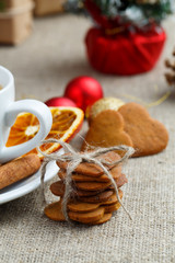 Gingerbread cookies on table and orange slice.