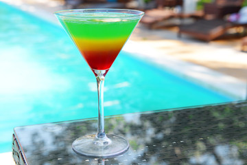 Cocktail on swimming pool background
