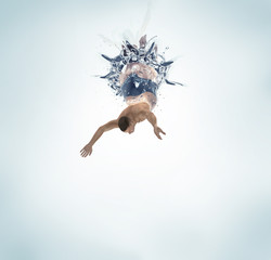 man diving into water isolated on white