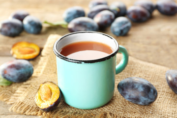 Plum Juice in a mug with fresh fruits