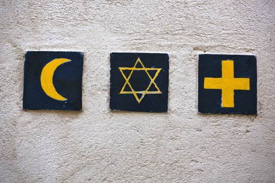 Set of 3 religious symbols: islamic crescent, jewish David's star, christian cross (wall sign on the street of Segovia, Spain) 