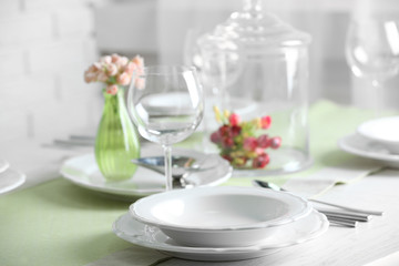 Table set at restaurant on light background