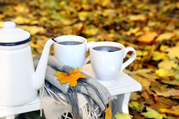 Autumn composition with hot beverage on nature background