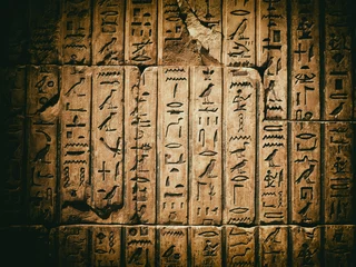Foto op Canvas Verweerde oude Egyptische hiëroglief uitgehouwen in zandsteen © kmiragaya