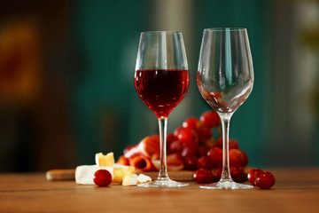 Empty and full wineglasses with grape on the table