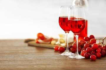 Two wineglasses with grape on the table