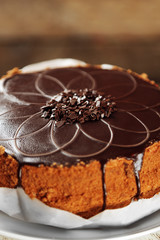 Tasty chocolate cake on wooden background