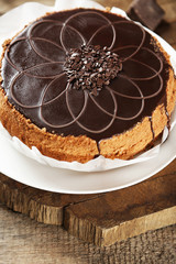 Tasty chocolate cake on wooden background