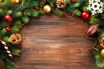 Christmas fir tree branches with toys on wooden table