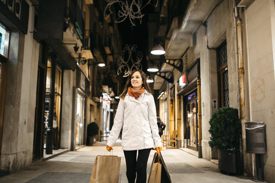 Happy woman holding shopping bags and smiling
