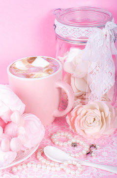 Cute set of pink princess accessories and sweets. Bottle with mastic flowers, big peach rose, zefir, cup of cacao with marshmellow, little spoon and pearl jewerly.