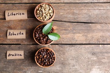 Collection of coffee beans on old wooden table, close up