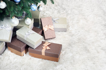 Christmas tree with presents on the floor in a room