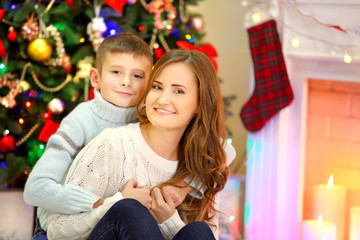 Fototapeta na wymiar Mother with son near Christmas tree
