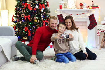 Happy family making photo in home holiday living room
