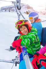 Little skier on ski lift