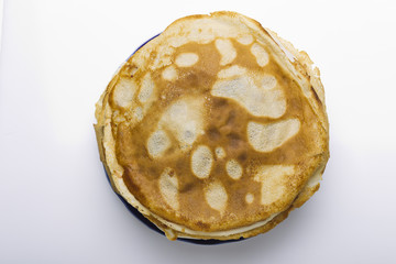 Pancakes on a plate on a white background