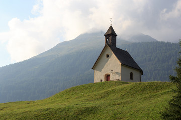 Fototapeta na wymiar Holy spirit chapel in alpine village Bichl with mountain, Austria