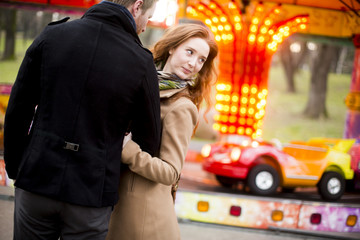Young couple in the amusement park