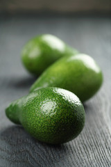 ripe green avocados on wood table
