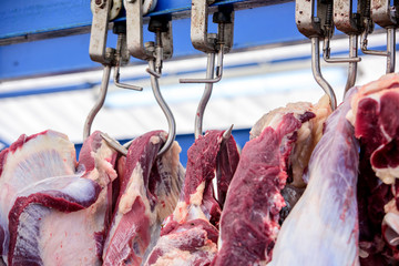 slaughterhouse cows, hanging on hooks