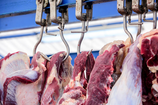 slaughterhouse cows, hanging on hooks