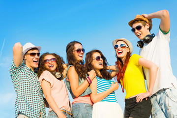 group of young people wearing sunglasses and hat