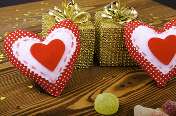 Red hearts, two golden gift and fruit candy.