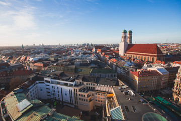Fototapeta na wymiar Beautiful super wide-angle sunny aerial view of Munich, Bayern, Bavaria, Germany with skyline and scenery beyond the city, seen from the observation deck of St. Peter Church 