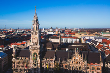Fototapeta na wymiar Beautiful super wide-angle sunny aerial view of Munich, Bayern, Bavaria, Germany with skyline and scenery beyond the city, seen from the observation deck of St. Peter Church 