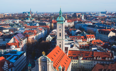 Naklejka na ściany i meble Beautiful super wide-angle sunny aerial view of Munich, Bayern, Bavaria, Germany with skyline and scenery beyond the city, seen from the observation deck of St. Peter Church 