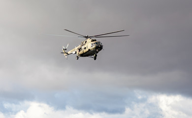 Fototapeta na wymiar Russian army Mi-8 helicopter in action against cloudy sky