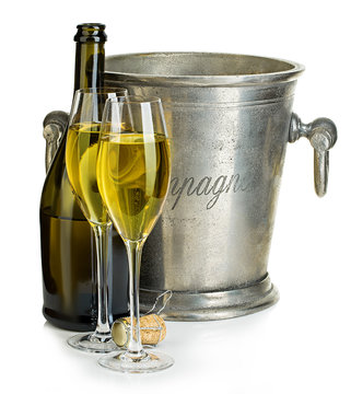 Champagne bottle with bucket ice and glasses of champagne, isolated on white.