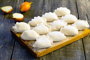 Raw dumplings with potatoes, selective focus.