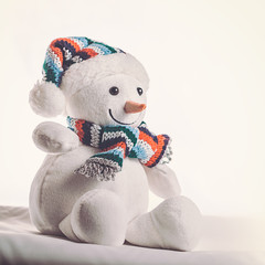 Toy snowman on a white background. Can be used as background for greeting cards and other images.